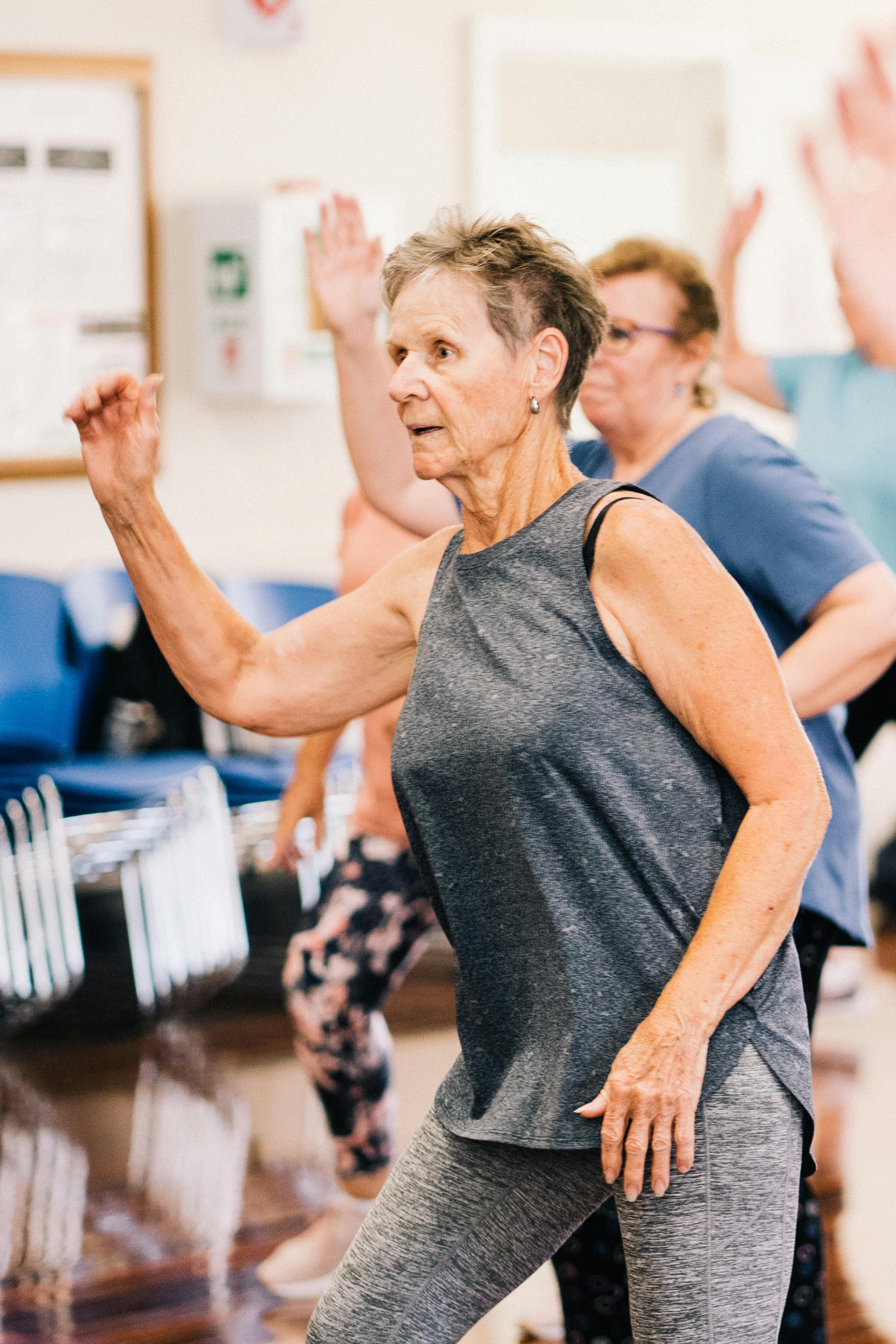 An adult exercising confidently with guided support